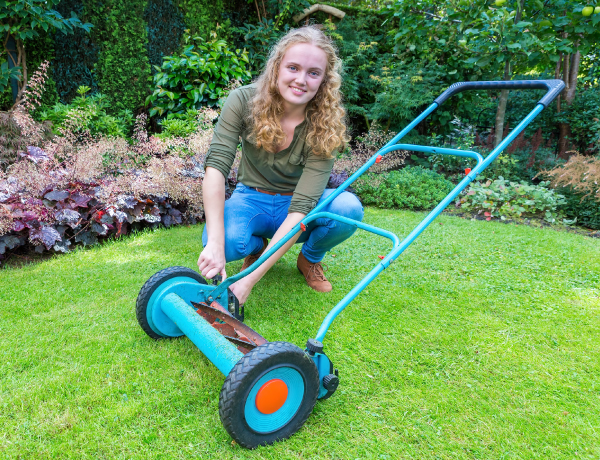 teen girl mowing lawn