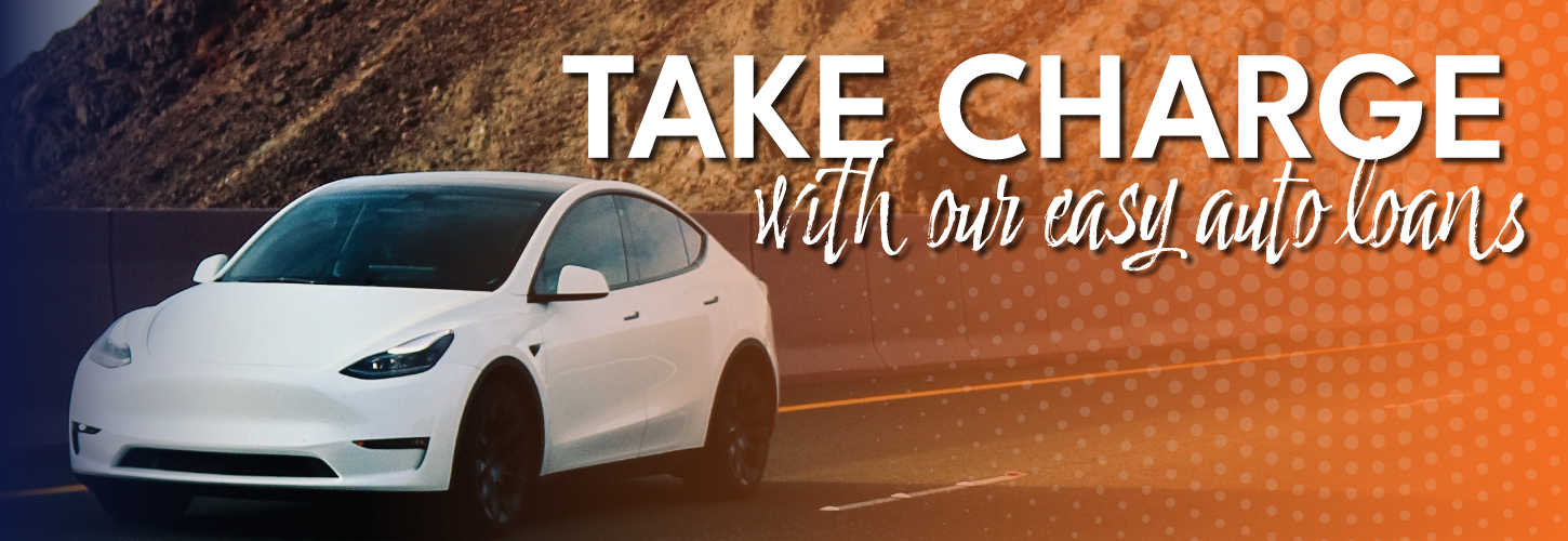 car diving on mountain road with the words take charge with our easy auto loans