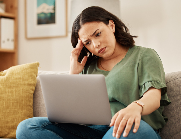 distressed woman looking at laptop